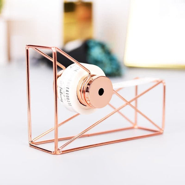 Tape dispenser made of rose gold metal